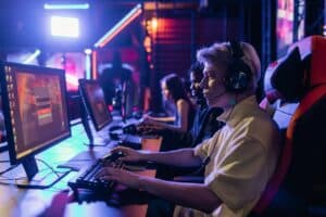 Image Title: Accessible Immersive Gaming Setup Image Description: Gamers engaging with affordable immersive technology at a gaming station. Alt Text: Budget Immersive Gaming Source: https://www.pexels.com/photo/a-man-with-black-and-silver-headphones-7862517/