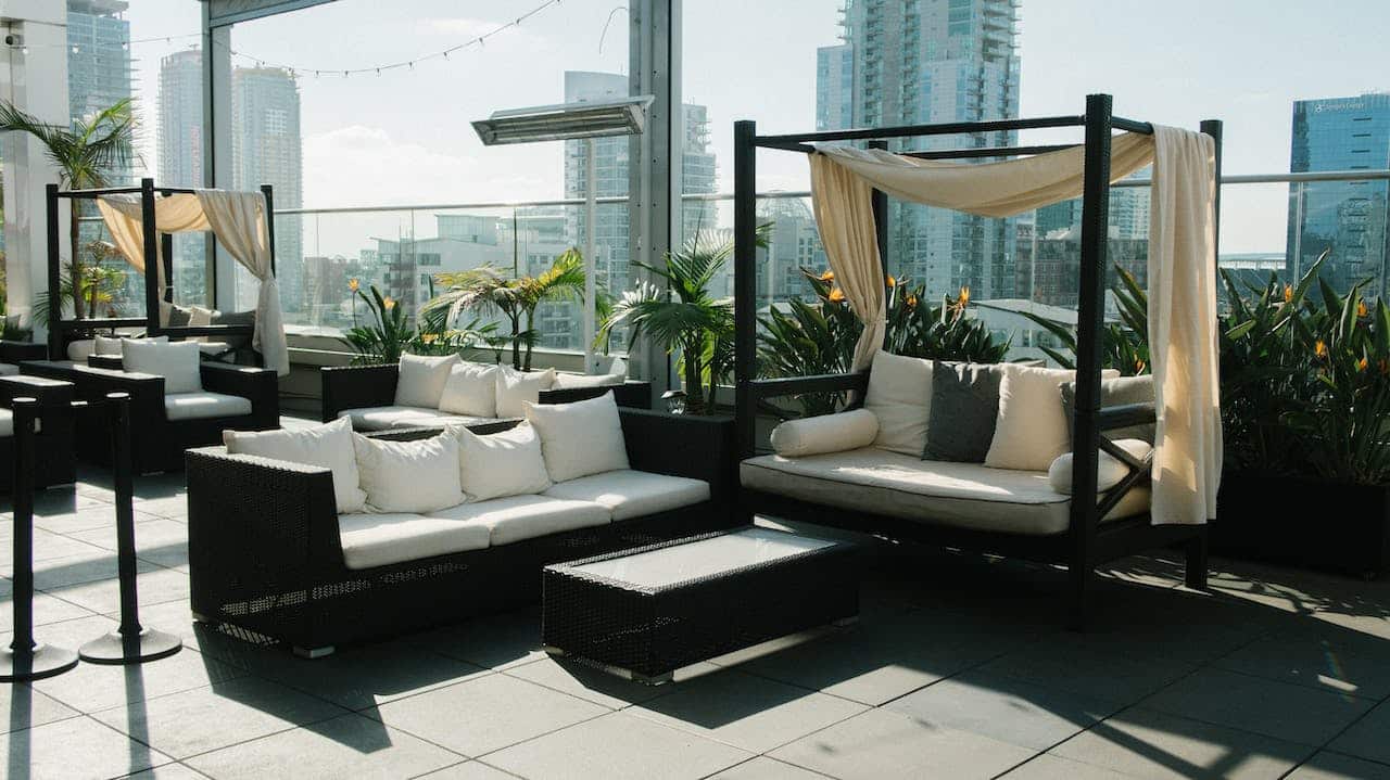 Photo by Athena: https://www.pexels.com/photo/white-and-black-couch-2972890/ -- rooftop venue