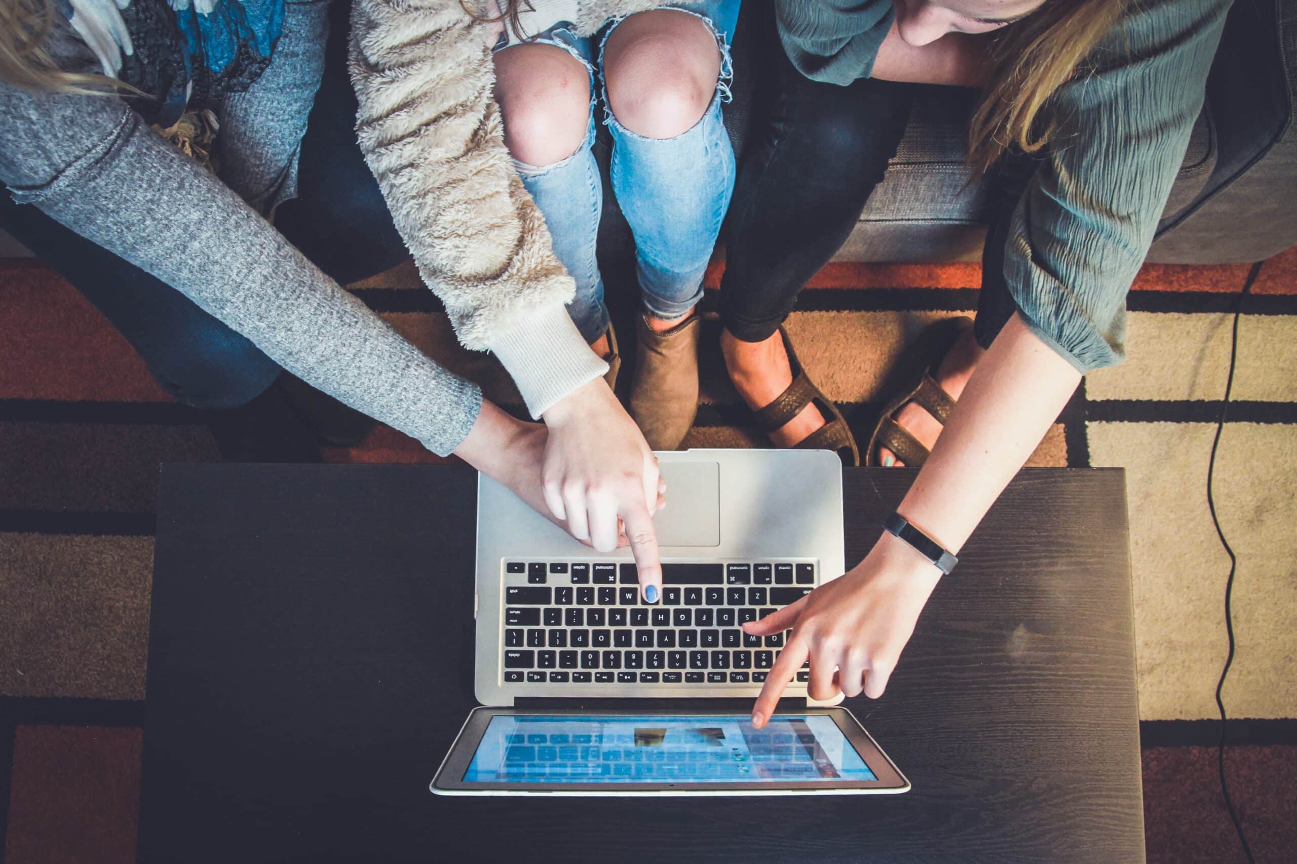 Source: https://unsplash.com/photos/three-person-pointing-the-silver-laptop-computer-2FPjlAyMQTA Title: Brand Awareness Alt. Title: Influencer Marketing for Event Promotion Description: Three people focusing on a page on a computer