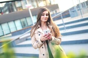 Photo by JÉSHOOTS: https://www.pexels.com/photo/affair-communication-girl-mobile-phone-7394/ -- professional woman texting