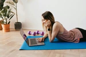 Photo by Karolina Grabowska: https://www.pexels.com/photo/slim-woman-browsing-laptop-on-yoga-mat-4498452/ -- yoga