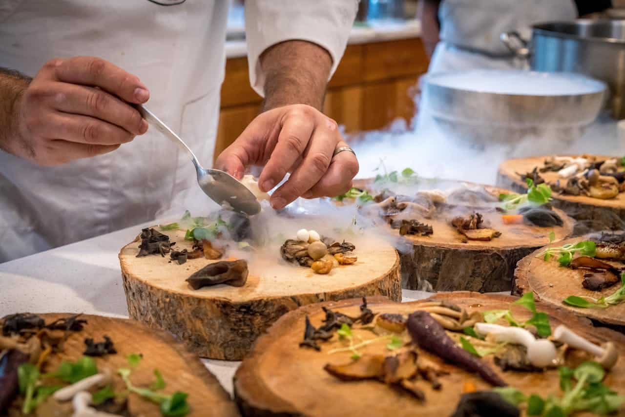 Photo by ELEVATE: https://www.pexels.com/photo/chef-preparing-vegetable-dish-on-tree-slab-1267320/ -- catering chef art