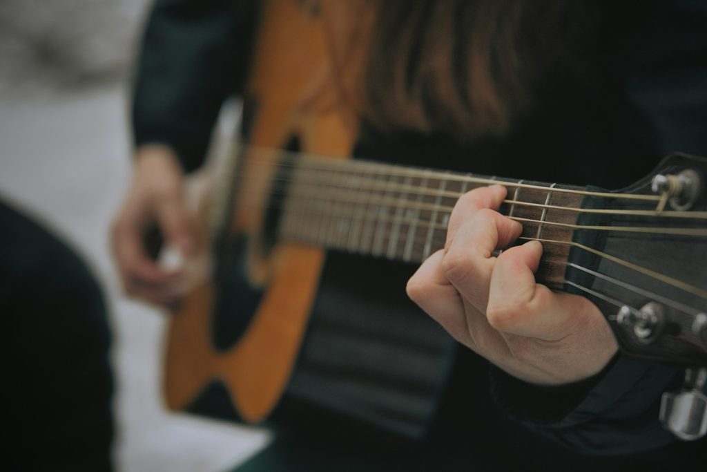 https://unsplash.com/photos/someone-is-playing-a-brown-acoustic-guitar-vom-EwMvcf4 Photo by Everett Pachmann on Unsplash