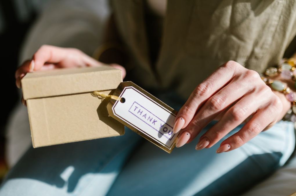https://www.pexels.com/photo/a-person-holding-a-box-with-a-thank-you-card-7309444/ Photo by RDNE Stock Project on Pexels