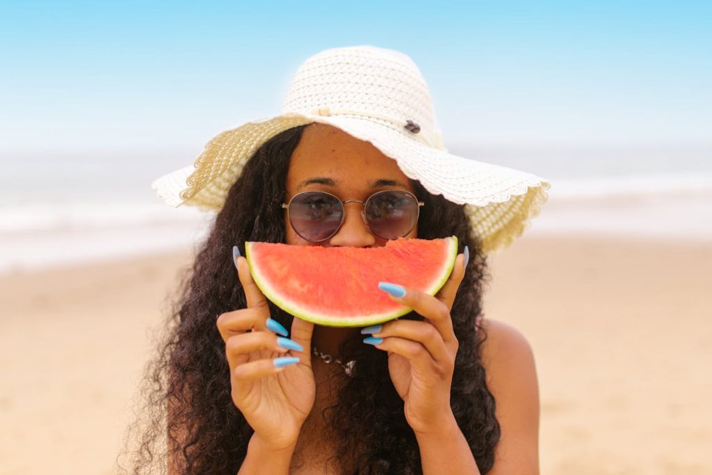 https://www.pexels.com/photo/woman-holding-a-slice-of-watermelon-8456598/ Photo by RDNE Stock Project on Pexels