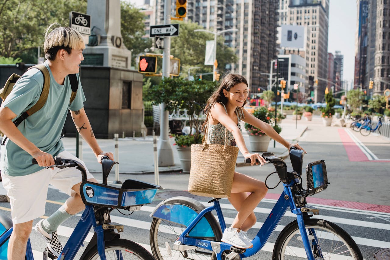 Photo by Samson Katt: https://www.pexels.com/photo/positive-diverse-couple-riding-bicycles-on-street-in-residential-district-5225319/