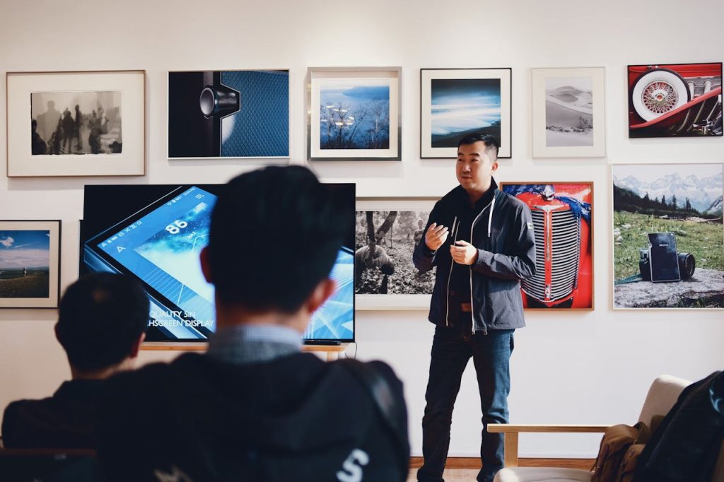 Photo by 祝 鹤槐: https://www.pexels.com/photo/man-beside-flat-screen-television-with-photos-background-716276/