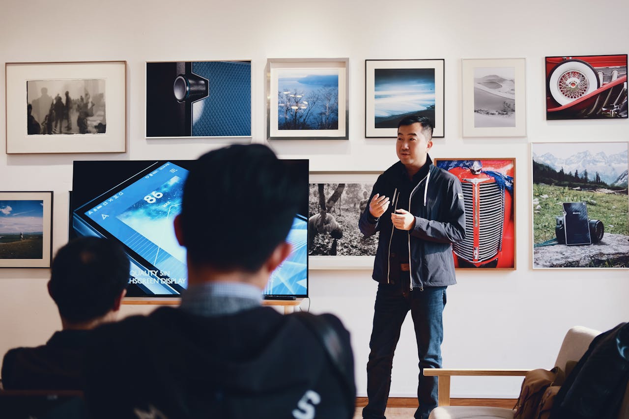 Photo by 祝 鹤槐: https://www.pexels.com/photo/man-beside-flat-screen-television-with-photos-background-716276/