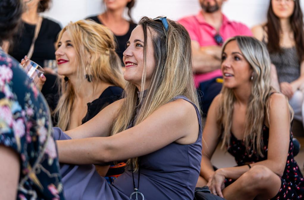 https://www.pexels.com/photo/a-group-of-women-sitting-in-a-room-and-smiling-27374276/ Photo by Nano Erdozain on Pexels