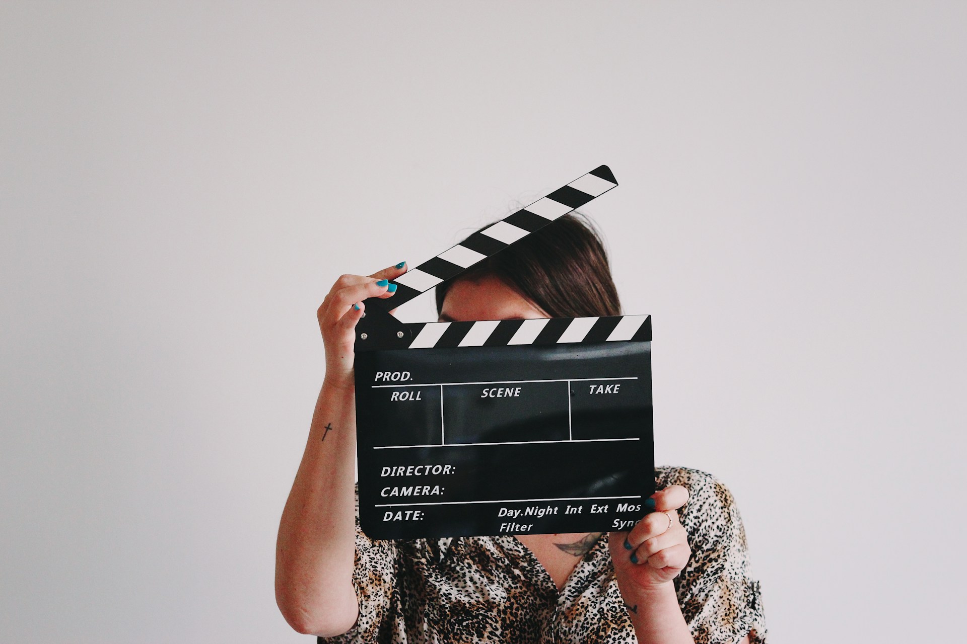 https://unsplash.com/photos/a-woman-holding-a-clapper-over-her-face-A-obUh61bKw Photo by Jon Tyson on Unsplash