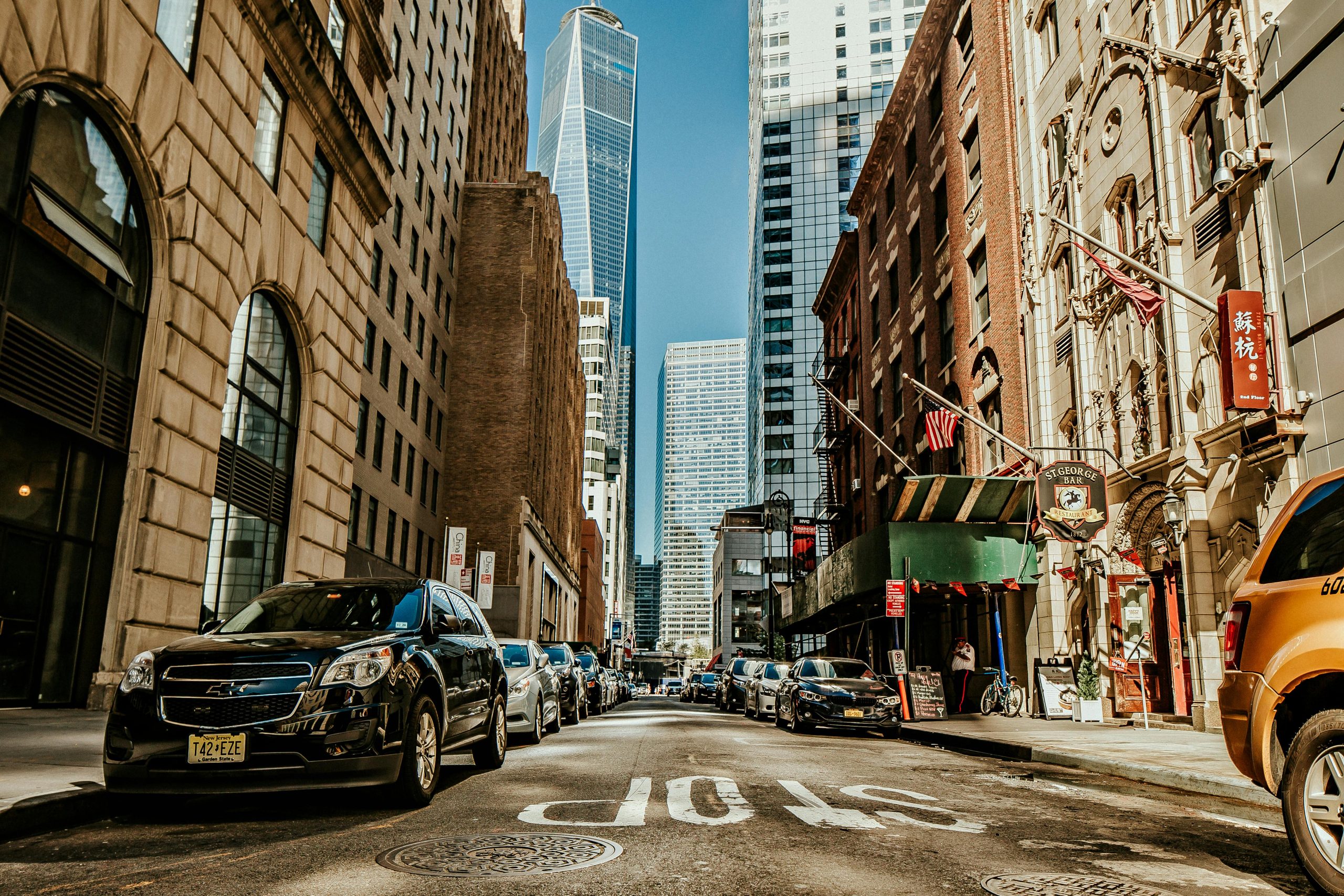 https://www.pexels.com/photo/vehicles-on-road-between-buildings-1389339/ Photo by Helena Lopes on Pexels