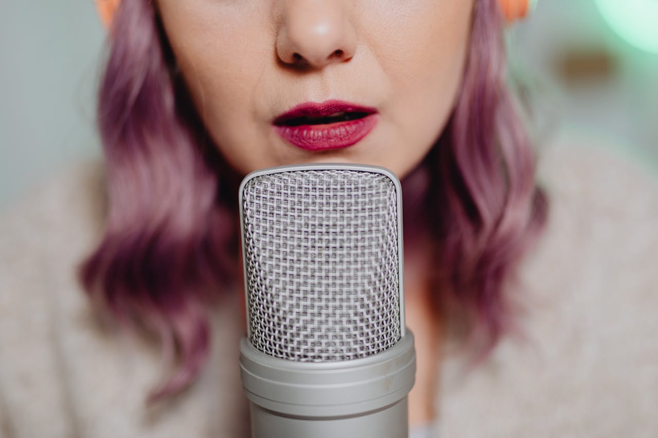 Photo by Photo By: Kaboompics.com: https://www.pexels.com/photo/a-woman-talking-on-a-microphone-6920066/
