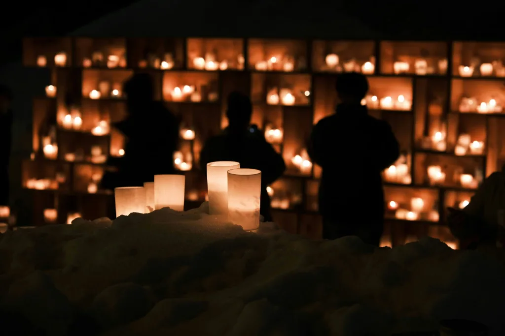 https://unsplash.com/photos/a-group-of-people-standing-in-front-of-a-wall-of-candles-Ofv7JFZZXw8 Photo by Seiya Maeda on Unsplash
