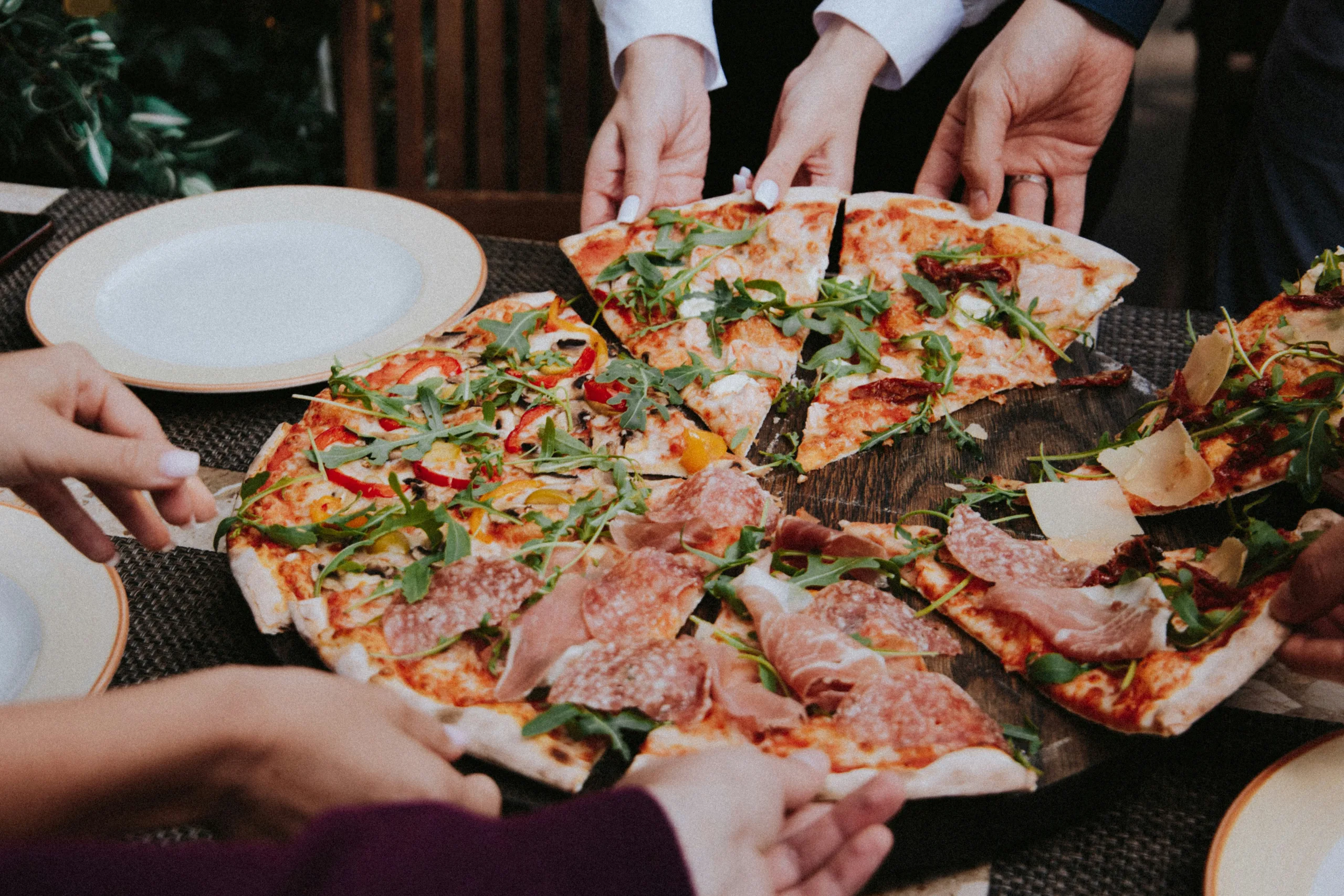 https://unsplash.com/photos/person-holding-pizza-on-white-ceramic-plate-5eoiyhGLFb4 Photo by Klara Kulikova on Unsplash