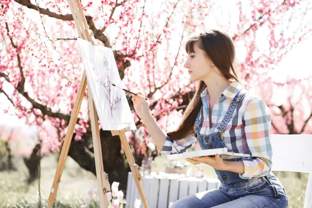 https://unsplash.com/photos/a-woman-sitting-in-front-of-a-cherry-tree-painting-a-picture-Xl5ac4dZsW0 Photo by Jennie Razumnaya on Unsplash