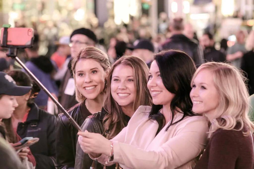 Photo by Following NYC: https://www.pexels.com/photo/group-of-friends-taking-a-selfie-in-a-crowded-urban-area-32164061/