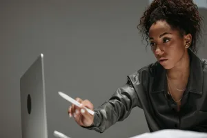 Photo by Pavel Danilyuk: https://www.pexels.com/photo/woman-holding-a-pen-pointing-on-laptop-screen-8000548/