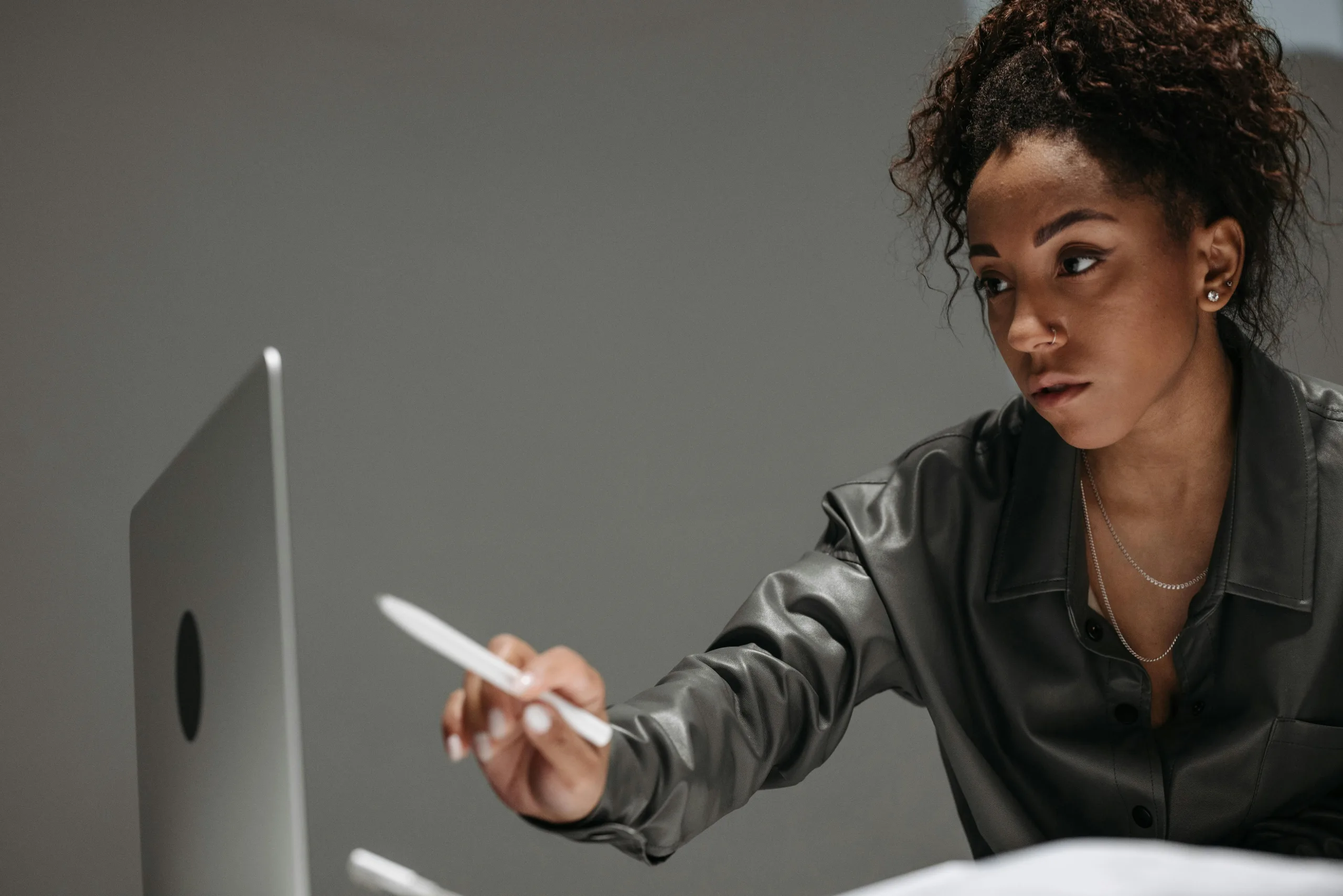 Photo by Pavel Danilyuk: https://www.pexels.com/photo/woman-holding-a-pen-pointing-on-laptop-screen-8000548/