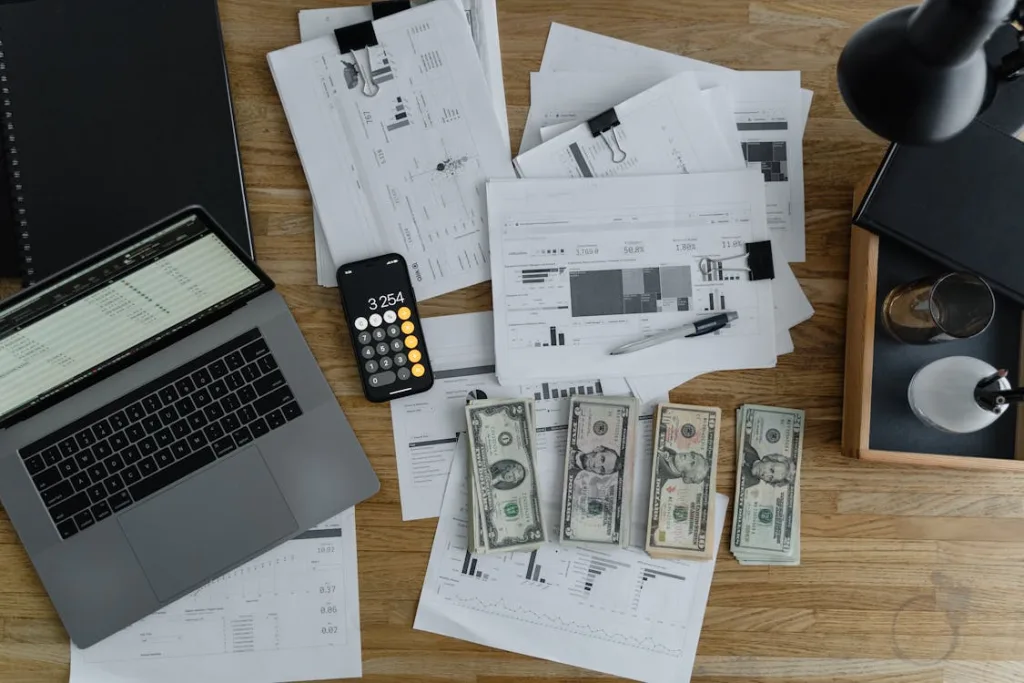 Photo by Tima Miroshnichenko: https://www.pexels.com/photo/a-laptop-near-the-dollars-and-papers-on-a-wooden-table-6693655/ 