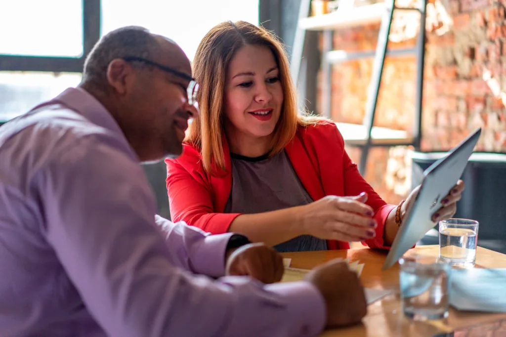 https://www.pexels.com/photo/a-woman-in-red-blazer-holding-an-ipad-12944654/