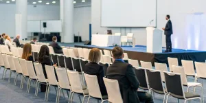 A business presentation in an event venue, where competitor analysis helps maximize attendance and success.