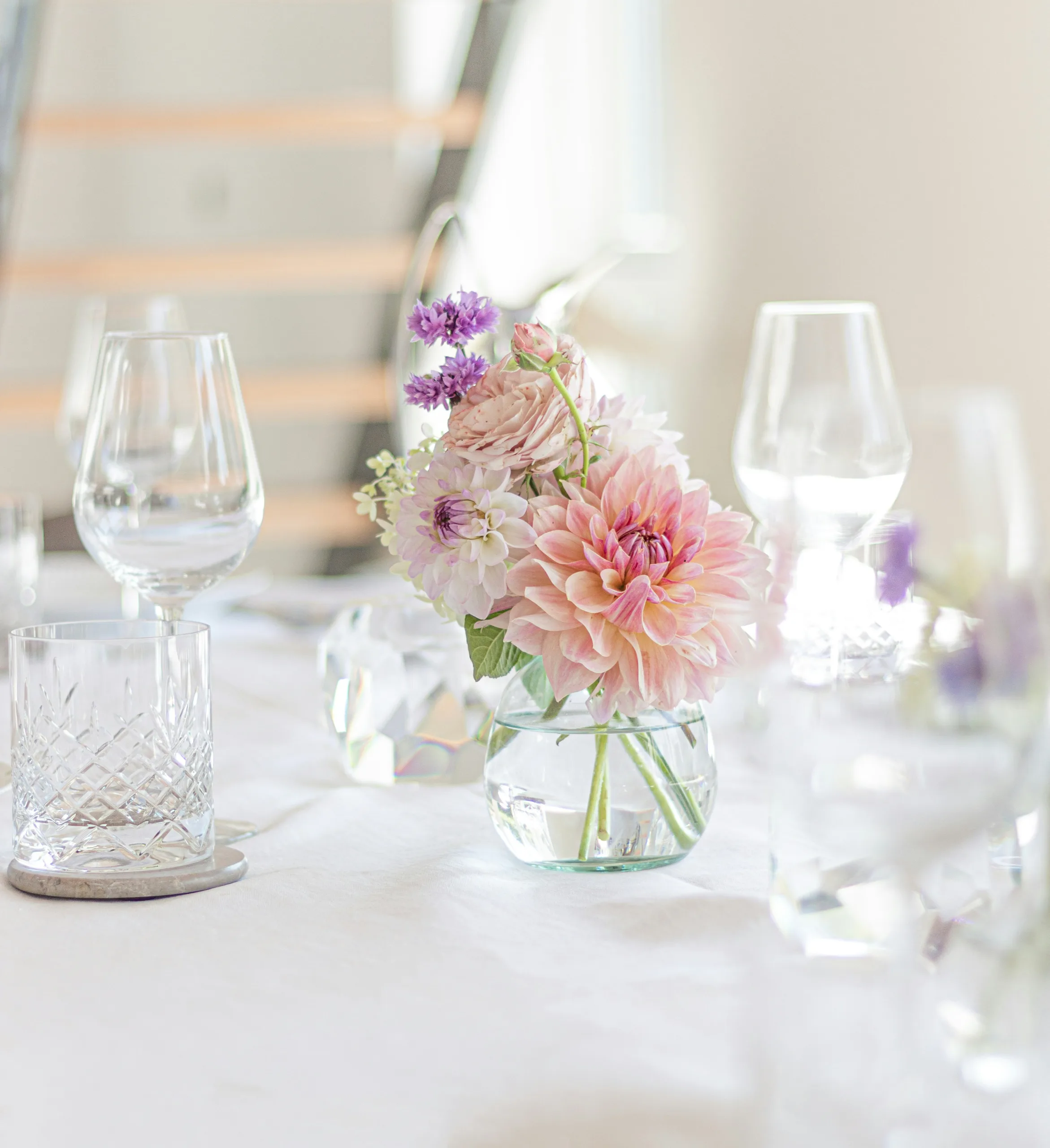 https://unsplash.com/photos/a-table-with-a-vase-of-flowers-and-wine-glasses-3uvj3mZkUUw