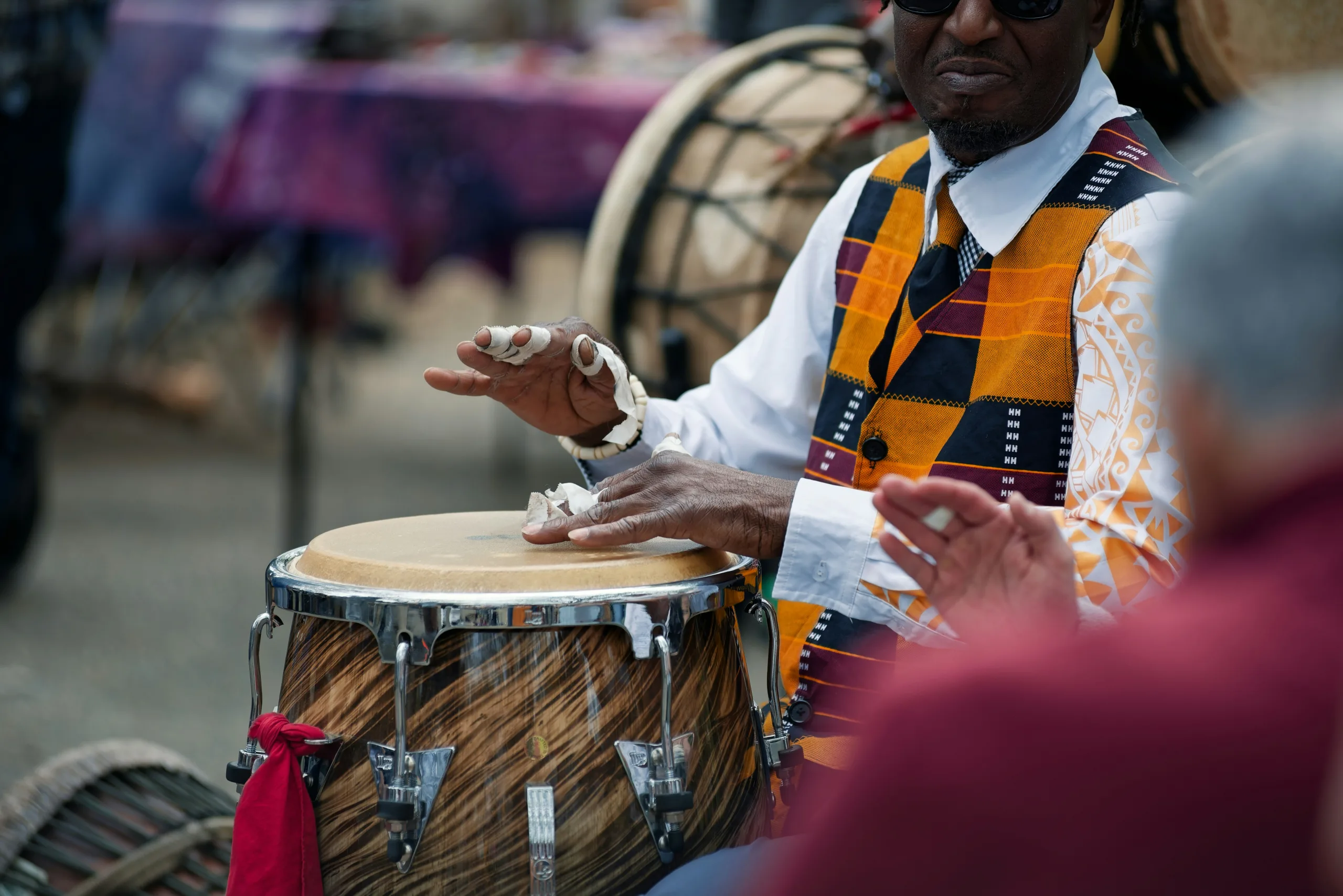 https://unsplash.com/photos/a-musician-plays-a-drum-at-an-outdoor-event-s32L5adnJ24 Photo by Michael Umoh on Unsplash