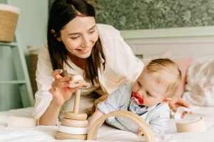 https://www.pexels.com/photo/mother-and-baby-boy-playing-with-wooden-toy-8504269/ Photo by Ivan S on Pexels