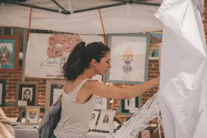 https://www.pexels.com/photo/woman-standing-near-paintings-holding-white-hammock-1670057/ Photo by Craid Adderley on Pexels