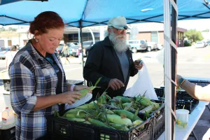 https://unsplash.com/photos/a-man-and-a-woman-at-a-farmers-market-ALgTVZA-B0g Photo by Judy Beth Morris on Unsplash
