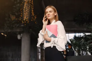 https://www.pexels.com/photo/businesswoman-with-notebook-calling-on-smartphone-in-cafe-4173265/