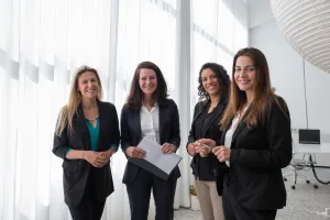 https://www.pexels.com/photo/a-group-of-women-standing-and-smiling-while-wearing-corporate-attire-8171224/