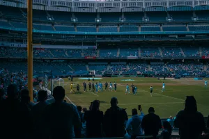 https://unsplash.com/photos/a-group-of-people-standing-on-top-of-a-soccer-field--_kPhmgL6KY Photo by Benjamin Cutting on Unsplash