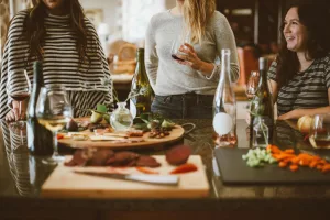 https://unsplash.com/photos/two-woman-standing-beside-woman-sitting-in-front-of-table-ZrhtQyGFG6s