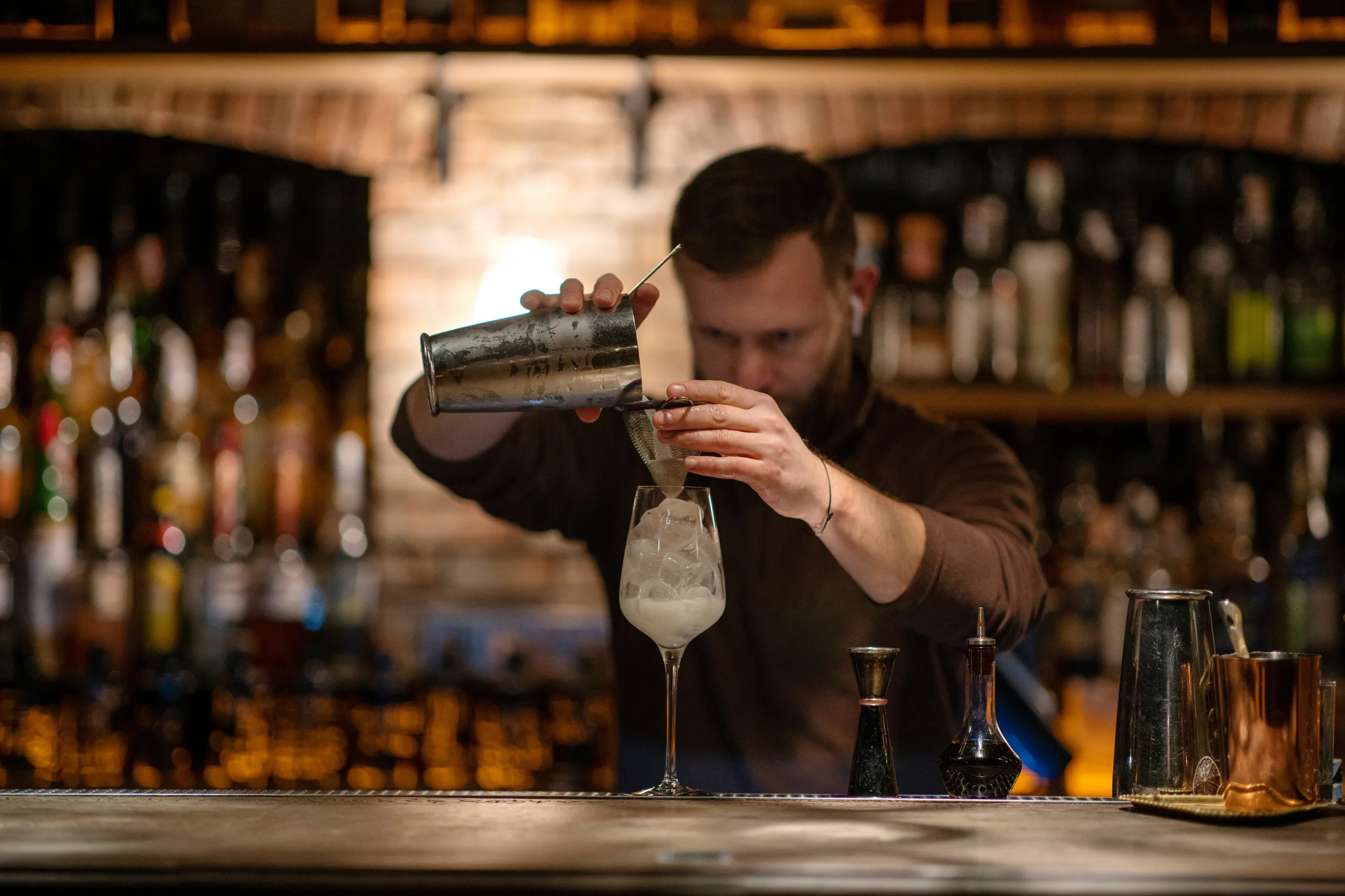 https://unsplash.com/photos/a-man-is-making-a-drink-at-a-bar-HN2ukPUF_og