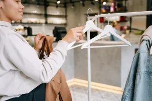Photo by Ivan S: https://www.pexels.com/photo/a-woman-holding-a-hanger-7990513/