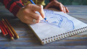 https://www.pexels.com/photo/close-up-of-a-person-drawing-in-a-sketchpad-22690796/