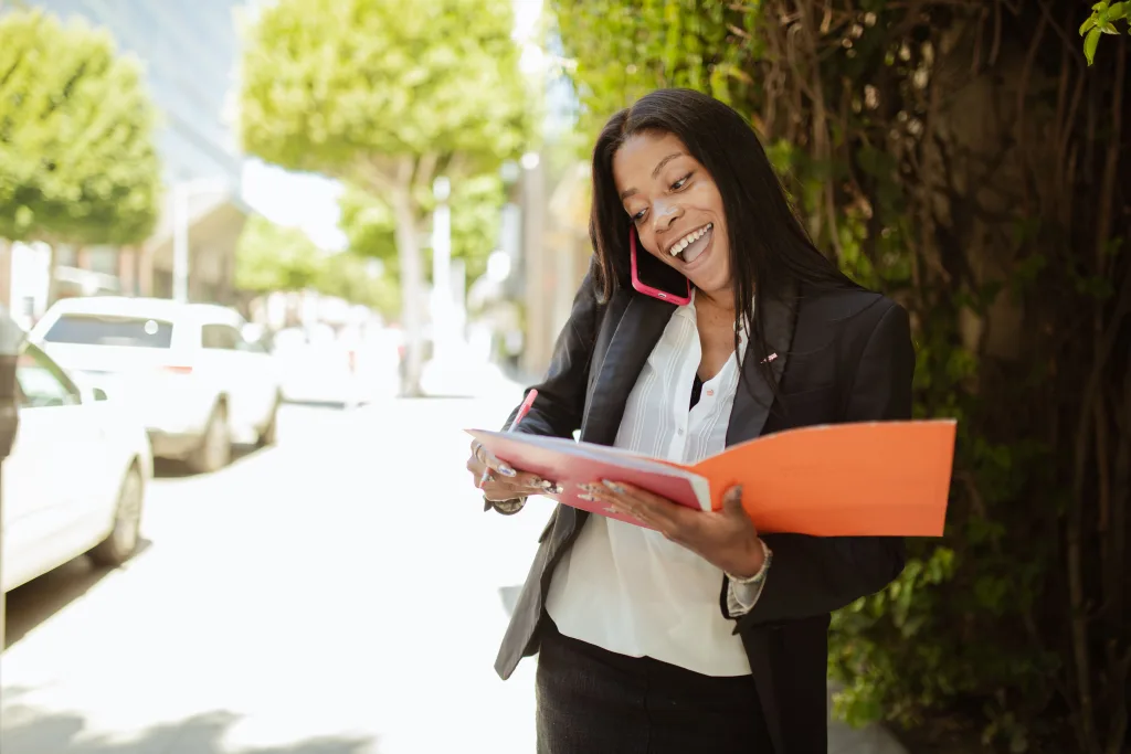 https://www.pexels.com/photo/woman-in-black-blazer-holding-papers-and-talking-on-the-phone-8052810/