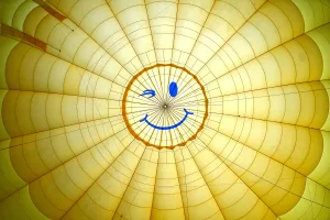 https://www.pexels.com/photo/smiling-face-on-yellow-fabric-18051081/